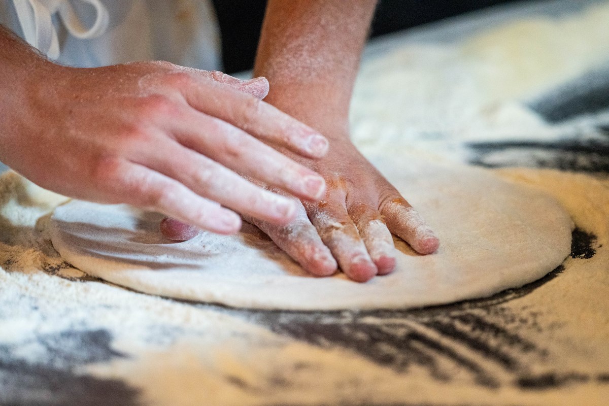 pressing our famous pizza dough