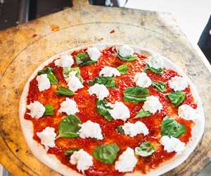 Margarita pizza going into the oven