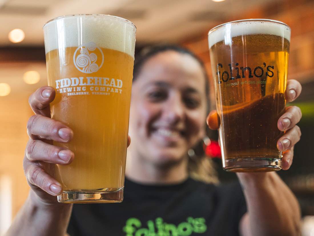 Folino's employee holding two pints of beer