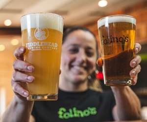 Folino's employee holding two pints of beer