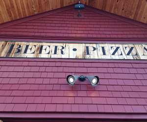 Close up of front door BEER - PIZZA wood sign