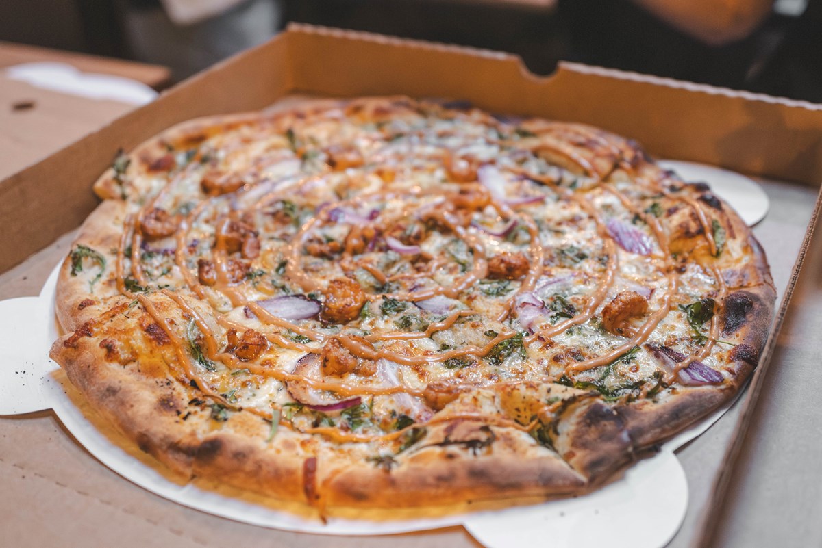 BBQ chicken pizza in a to-go box